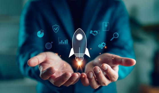 Businessman hands holding rocket icon with digital business elements.